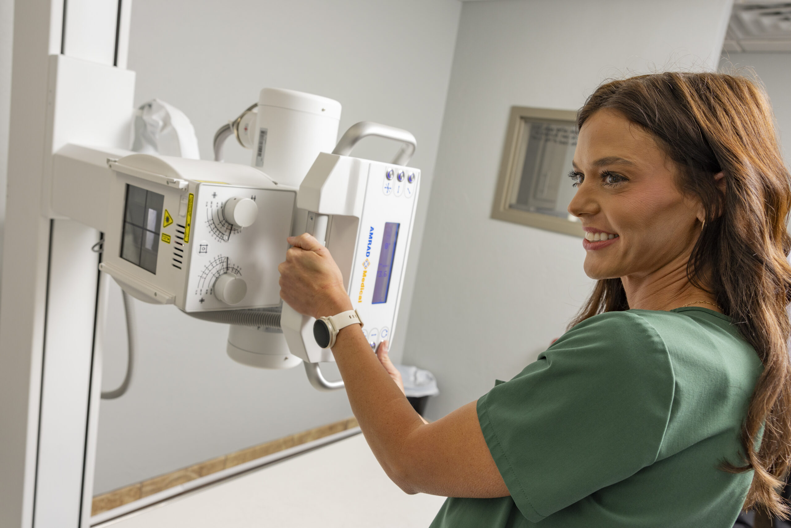 Healthcare professional preparing X-ray equipment at Classen Medical Complex.